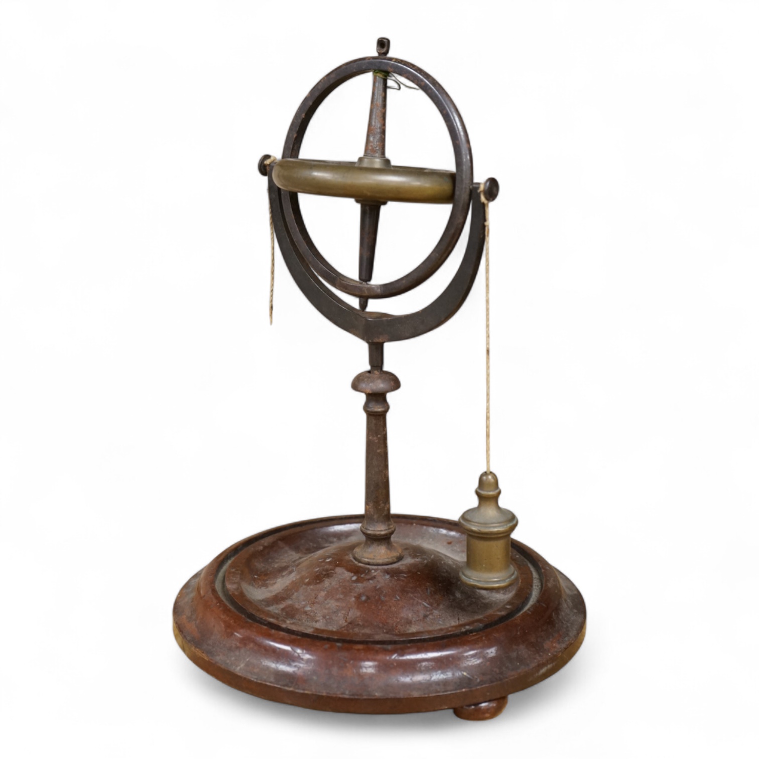 A 19th century brass gyroscope on a turned mahogany base, 26cm high.